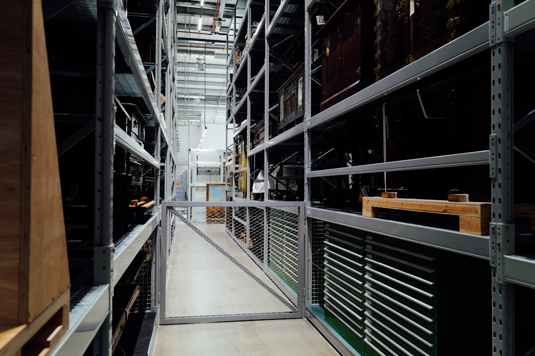 a-long-aisle-between-tall-storage-shelves-in-a-warehouse-af6fnq0zg3a